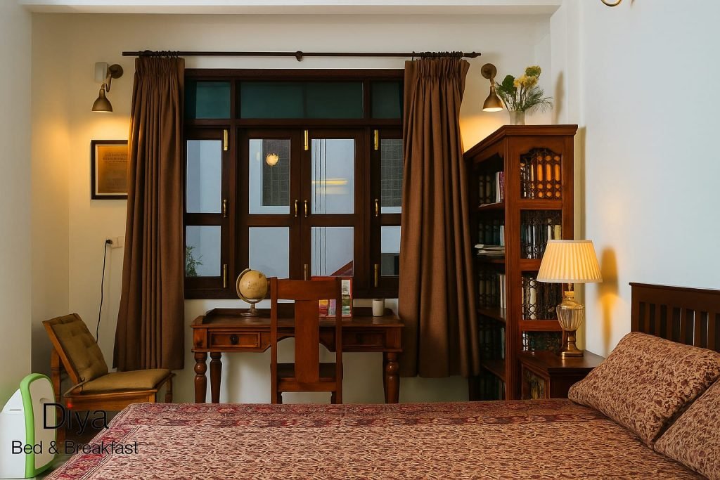 Cozy bedroom with wooden furniture, study desk, and bookshelf at Diya Bed & Breakfast.